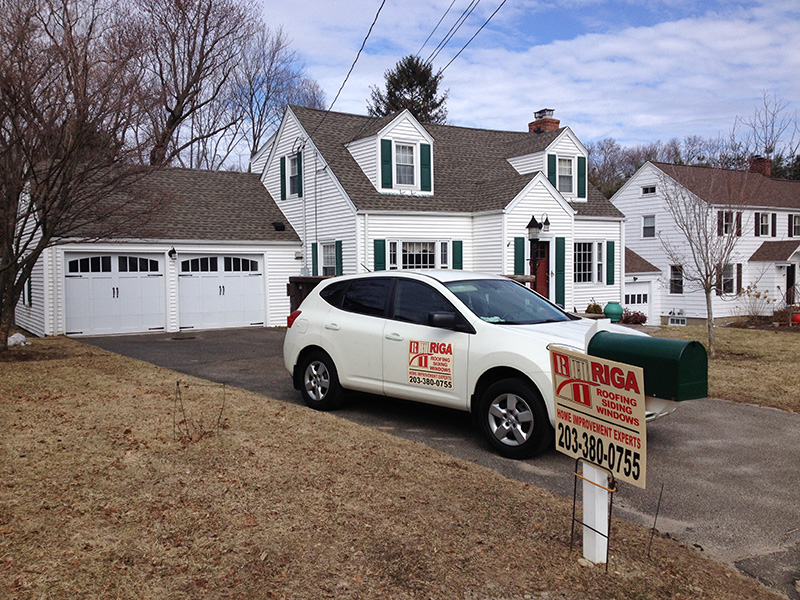 Trumbull, CT white house with green shutters – roofing, siding, windows, and gutters by Riga Home Pro