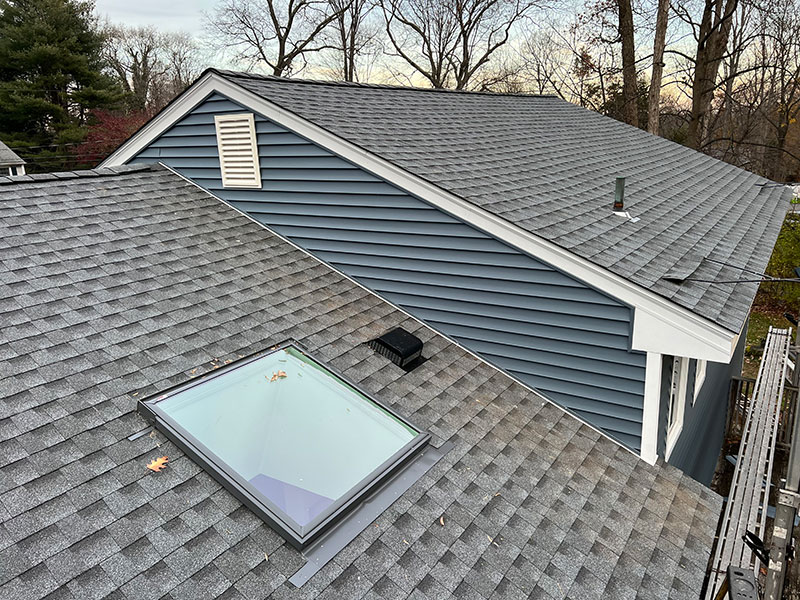 Roof replacement by GAF roofing system with Velux skylight in Fairfield, CT by Riga Home Pro