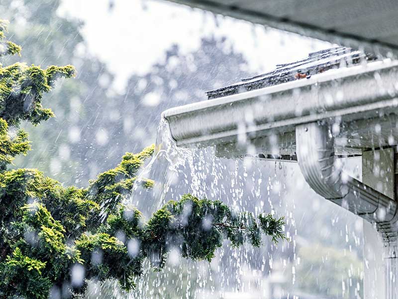 Heavy rain causing home damage, illustrating the impact of severe weather on residential properties