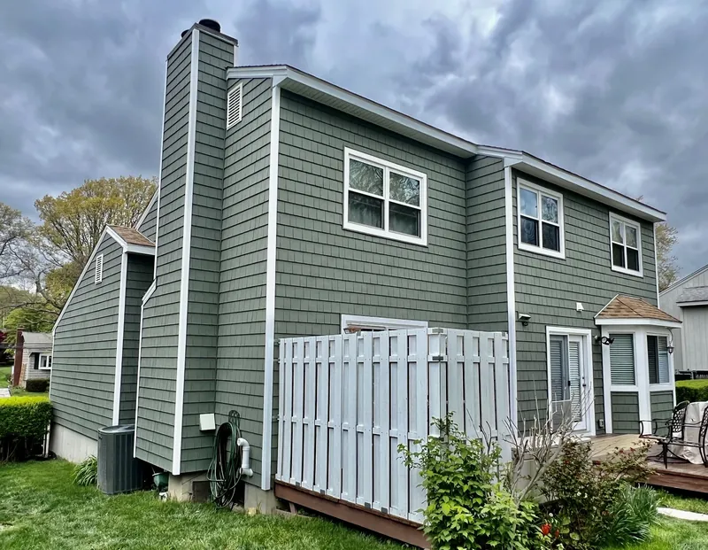 Vinyl siding and new gutters on a green home in Stamford, CT