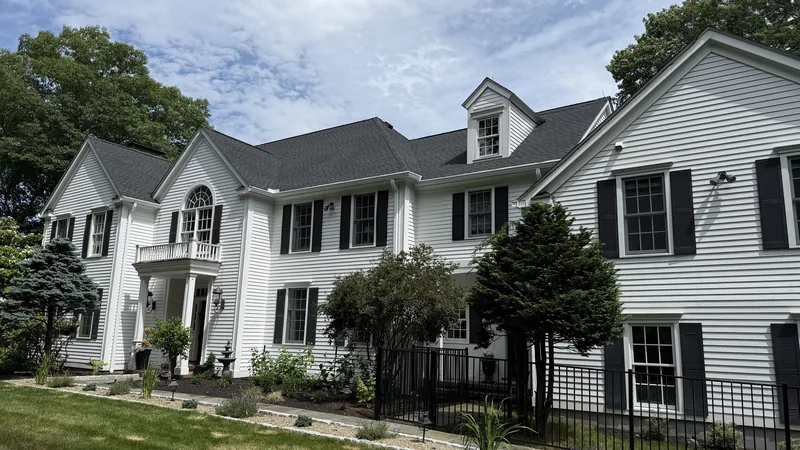 Completed roof replacement and seamless gutter installation on a home in Weston, CT