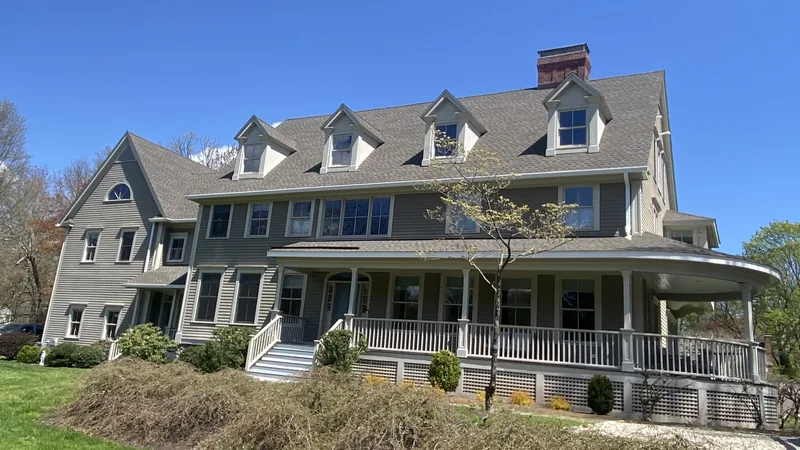 Completed roof replacement and seamless gutter installation on a home in Westport, CT
