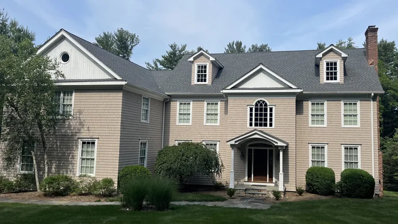 Completed roof replacement and seamless gutter installation on a home in Wilton, CT