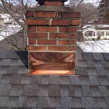A new GAF roof in charcoal with copper flashing installed by Riga Home Pro, top-rated roofing company in Trumbull, CT