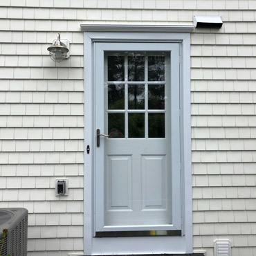 A new door and storm door with a new aluminum casing installed by top doors contractors Riga Home Pro in Southport, CT